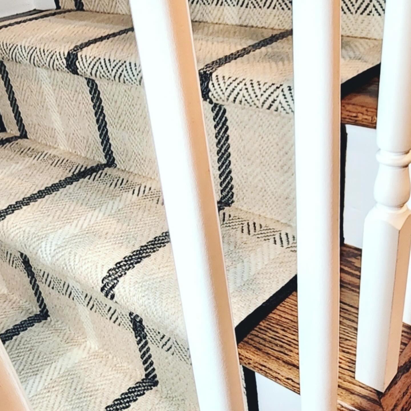 Patterned wool stair runner installed on hardwood stairs