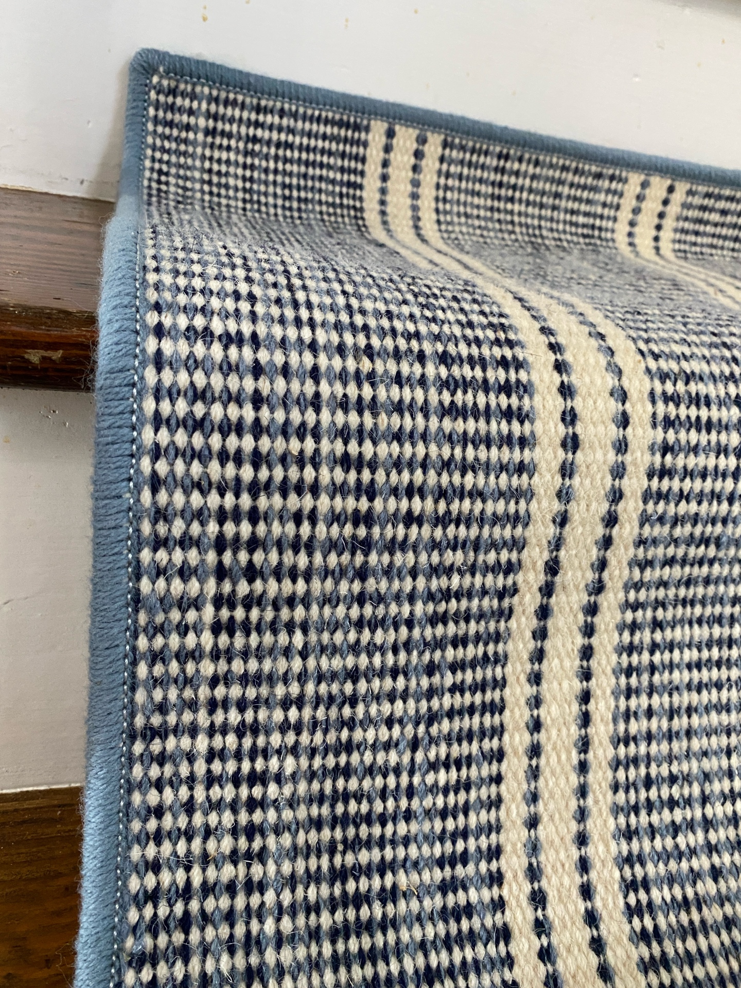 Herringbone wool stair runner installed on a staircase
