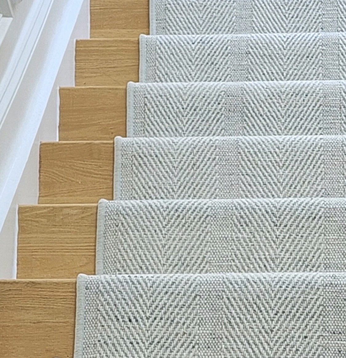 Striped wool stair runner installed on a staircase