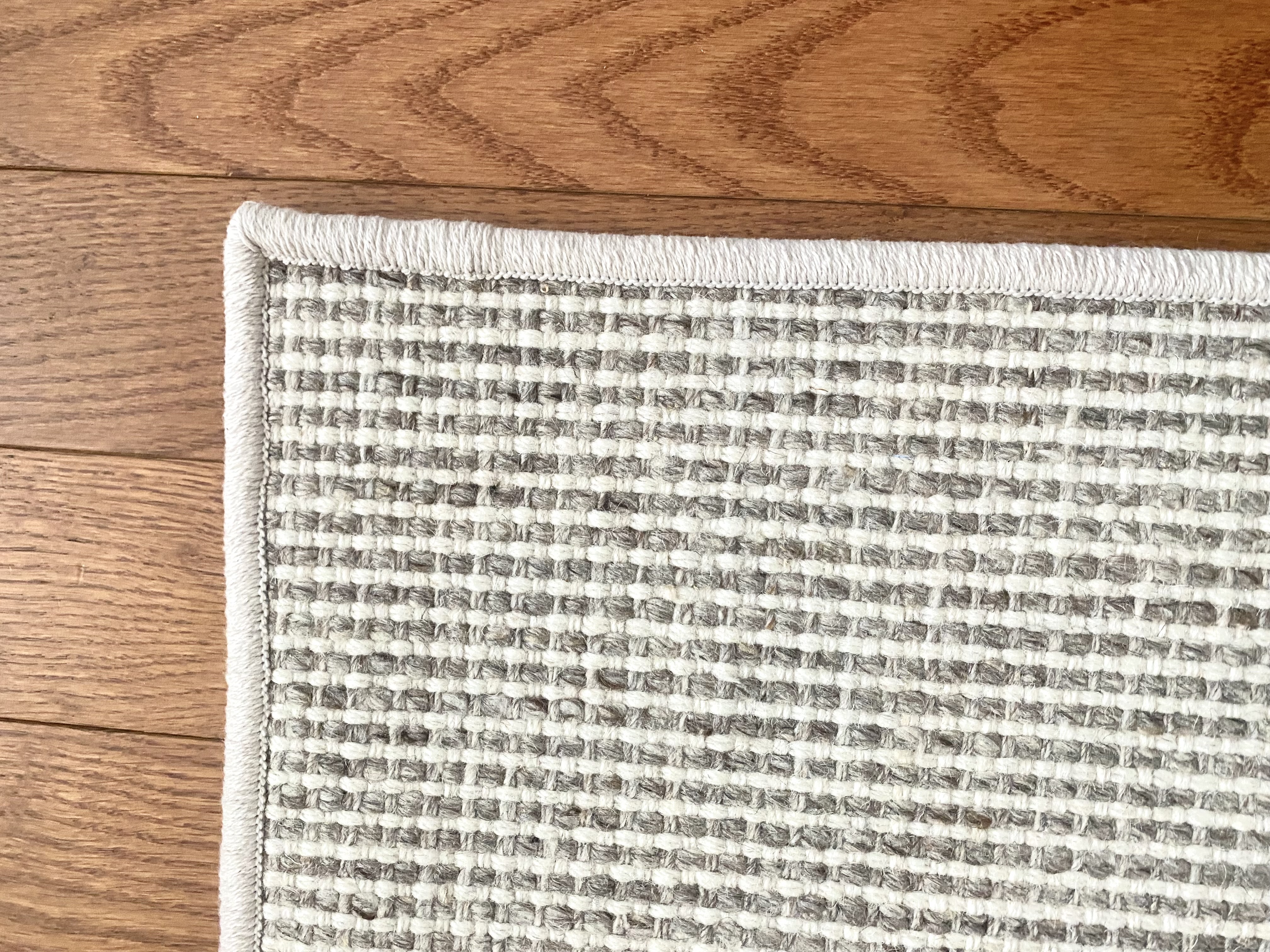 Close-up of premium wool carpet texture and finished stair runner edge