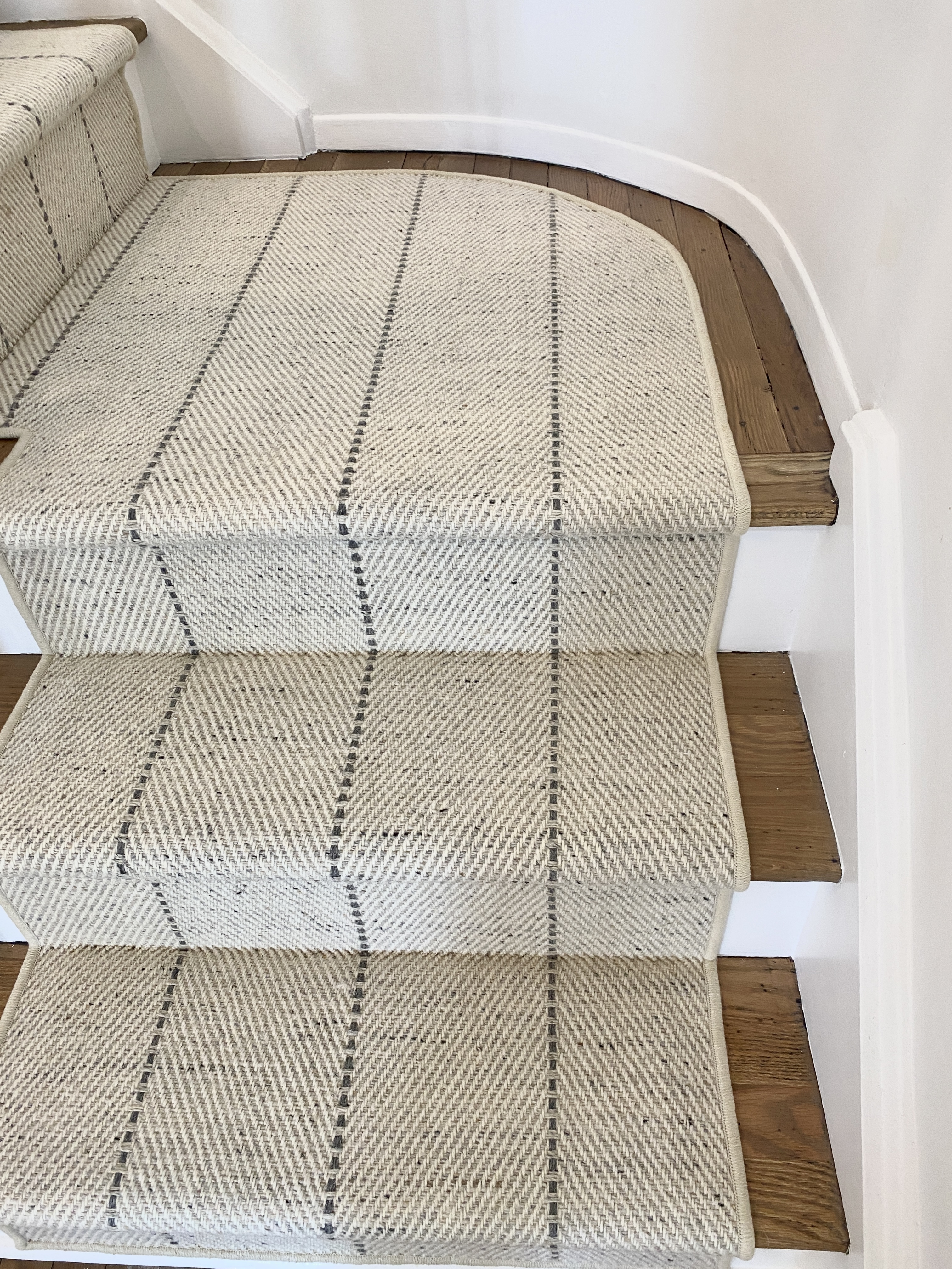 Close-up of wool stair runner pattern alignment on staircase