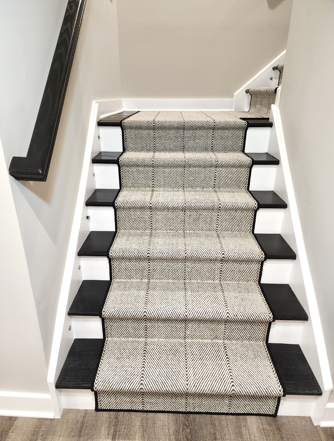 Custom wool stair runner installed on a hardwood staircase in New Jersey