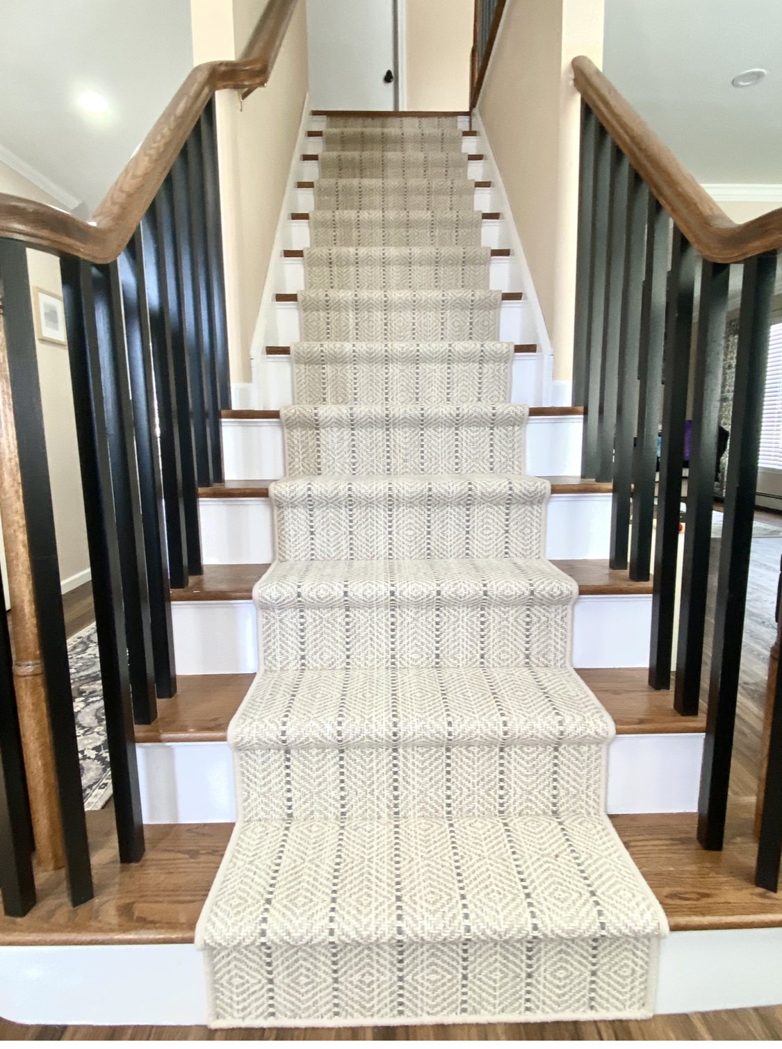 Modern neutral geometric patterned custom stair runner installed on wood stairs