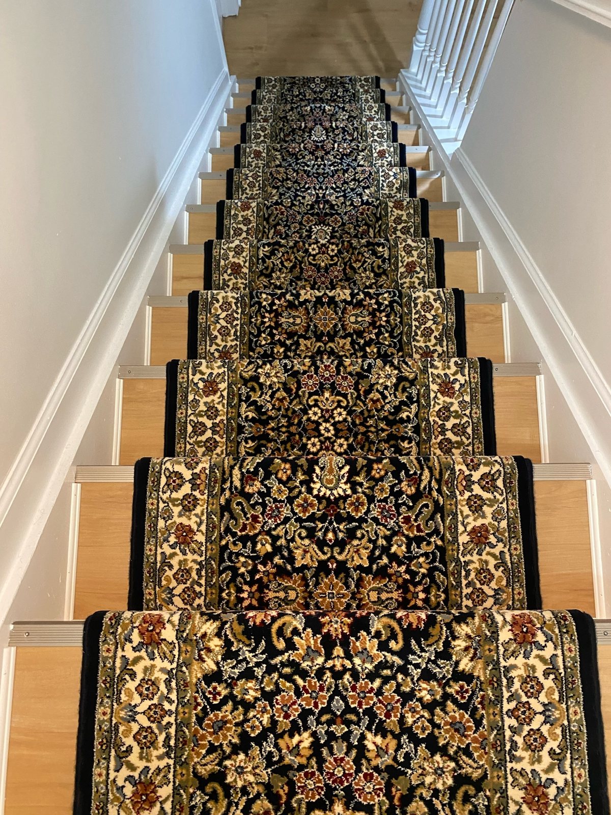 Traditional black Oriental-style stair runner with floral pattern and decorative border